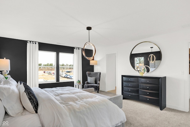 bedroom featuring light carpet and baseboards