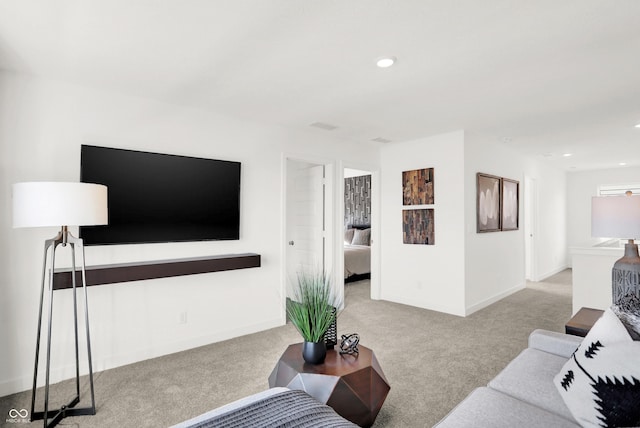 carpeted living area featuring recessed lighting and baseboards