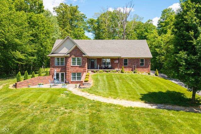 128 Walts Rd, Georgetown, IN 47122 - view of front of property with a patio area, brick siding, a front lawn, and a shingled roof