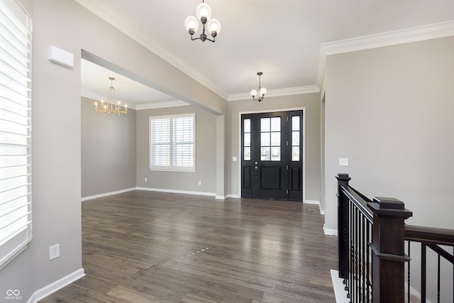 entryway featuring dark wood-type flooring, an inviting chandelier, and crown molding