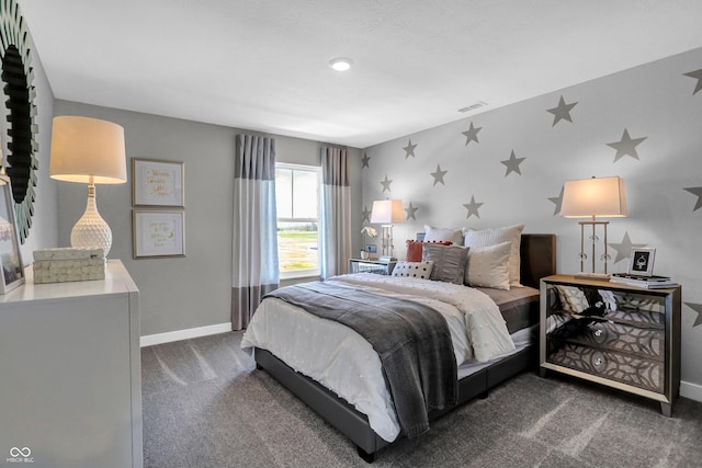 bedroom with visible vents, baseboards, and dark colored carpet