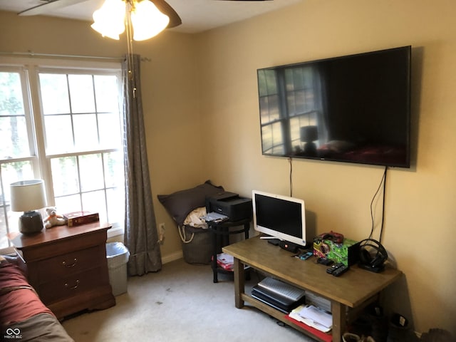 carpeted home office with baseboards and ceiling fan