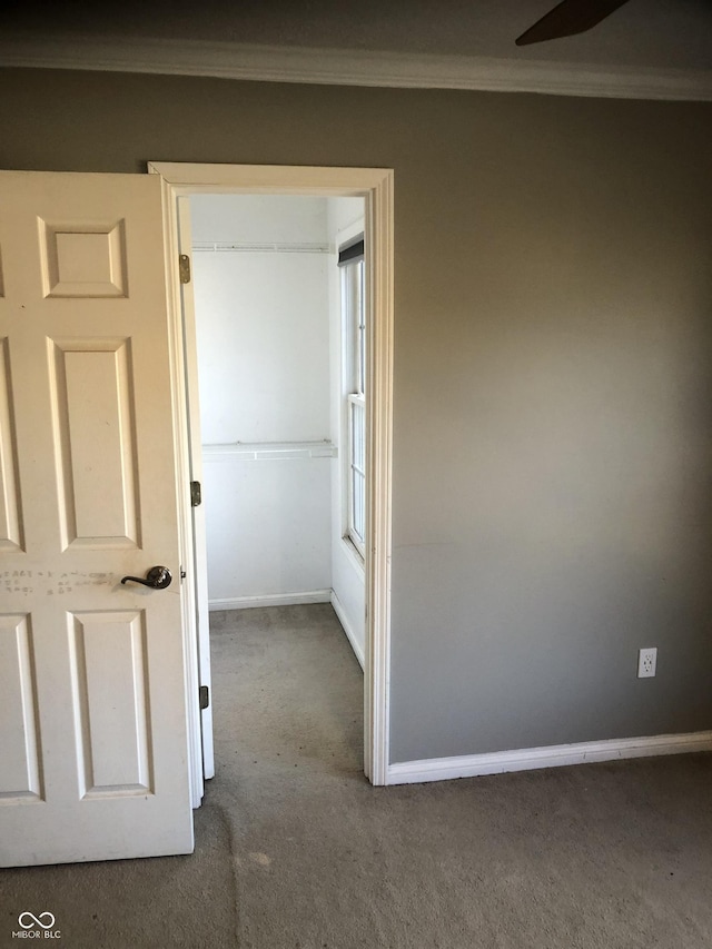 hall with carpet flooring and baseboards