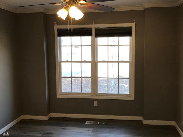 unfurnished room with baseboards, dark wood-style flooring, and ornamental molding