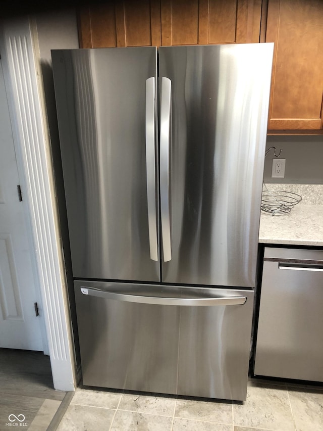 room details featuring brown cabinetry and stainless steel appliances