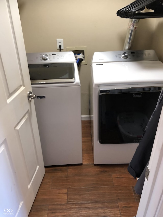 laundry room with washer and clothes dryer, laundry area, and dark wood-type flooring