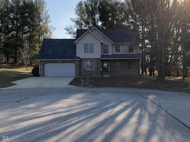 view of front of house featuring concrete driveway and a garage