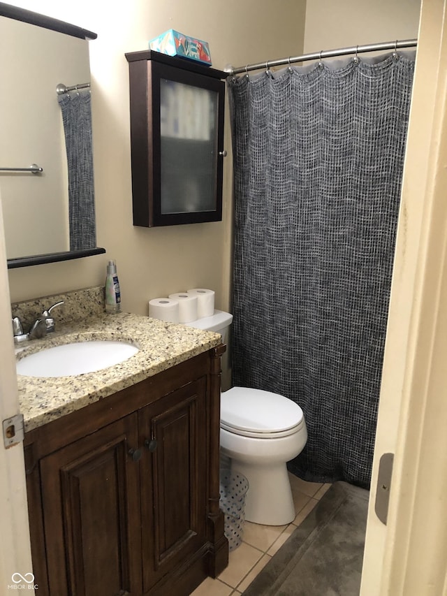 bathroom with vanity, tile patterned floors, curtained shower, and toilet