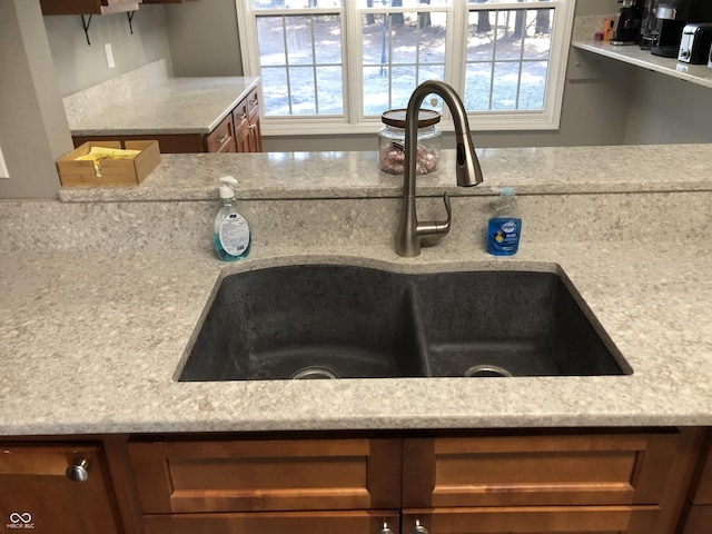 details with brown cabinetry and a sink