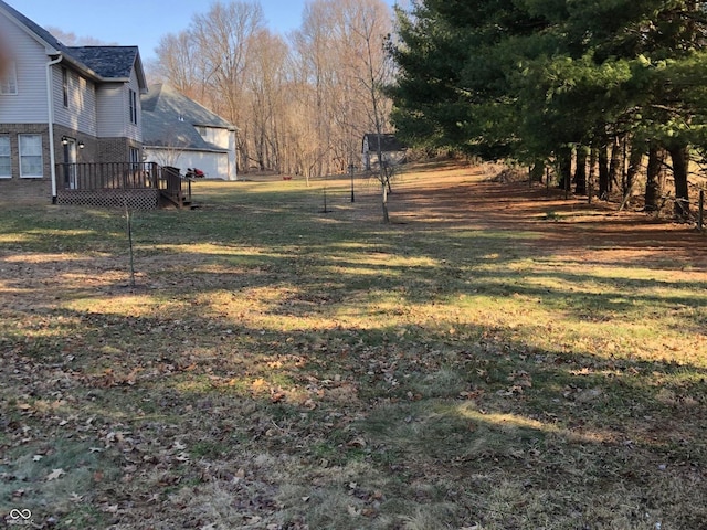 view of yard with a garage and a deck