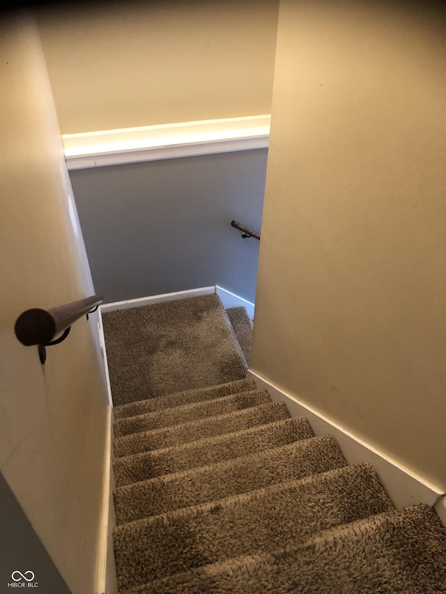 staircase with carpet flooring and baseboards