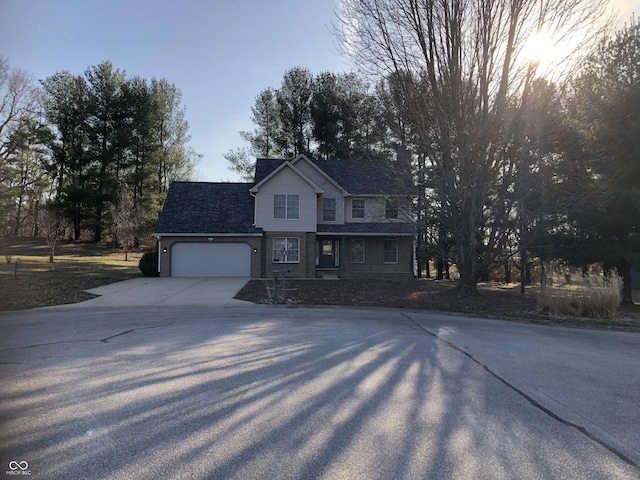 view of front of house with concrete driveway and an attached garage