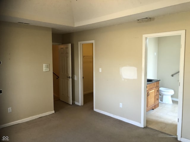 unfurnished bedroom with visible vents, light carpet, baseboards, and a spacious closet