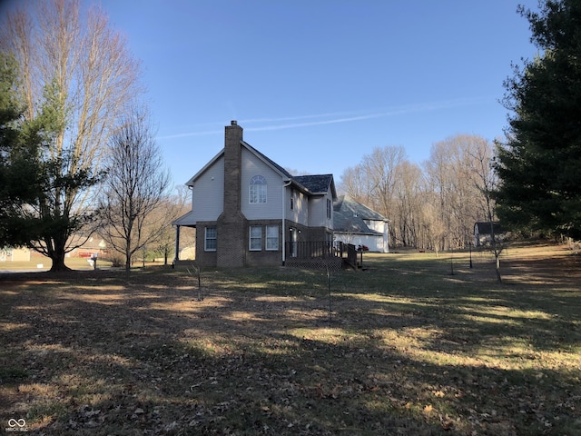 view of property exterior with a yard and a chimney