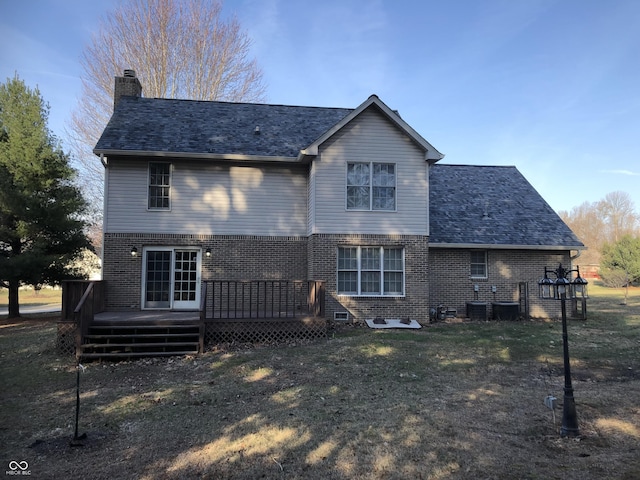 back of property featuring a lawn, a wooden deck, brick siding, central AC unit, and a chimney