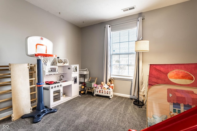 game room with visible vents, dark carpet, and baseboards