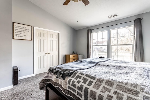 bedroom featuring radiator, visible vents, carpet floors, vaulted ceiling, and a closet