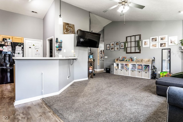 living room with visible vents, high vaulted ceiling, carpet, baseboards, and ceiling fan