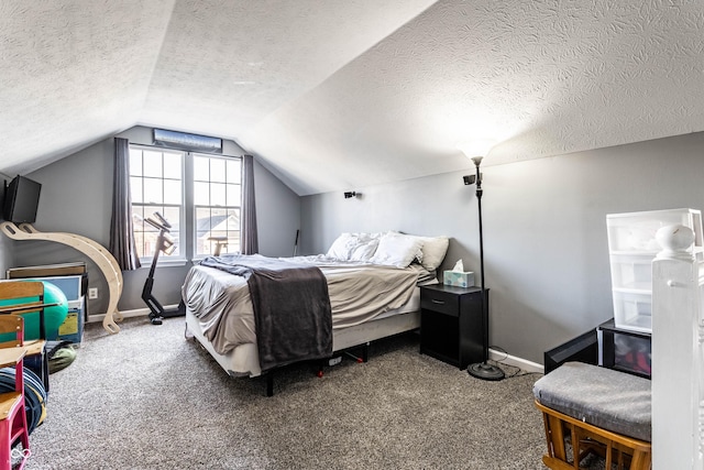 bedroom with lofted ceiling, carpet flooring, baseboards, and a textured ceiling