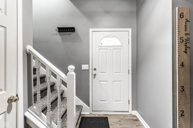 entrance foyer featuring light wood finished floors and baseboards