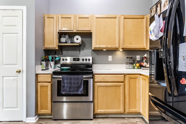 kitchen with light countertops, stainless steel range with electric stovetop, black fridge with ice dispenser, and light brown cabinets