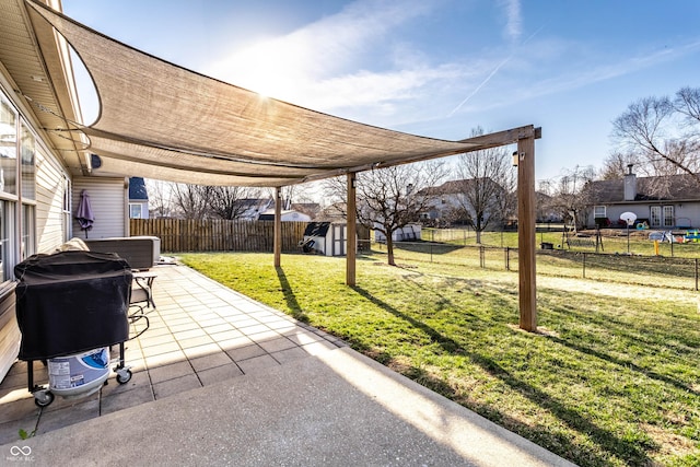 view of patio / terrace with a fenced backyard, a grill, an outdoor structure, and a shed