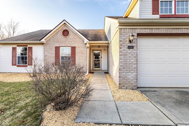 view of exterior entry with brick siding and roof with shingles