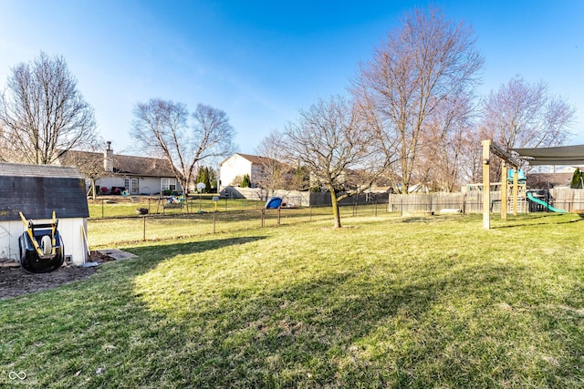 view of yard featuring a playground and fence