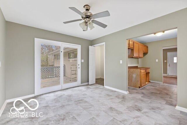 interior space featuring a ceiling fan and baseboards