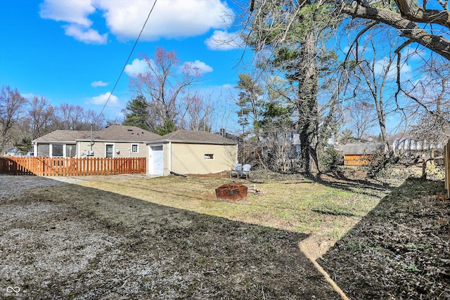 view of yard featuring a deck, an outbuilding, fence, and a garage