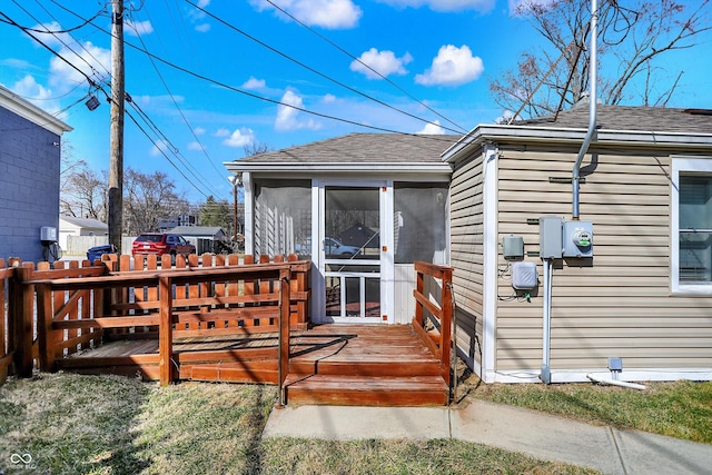 wooden deck with fence and a sunroom