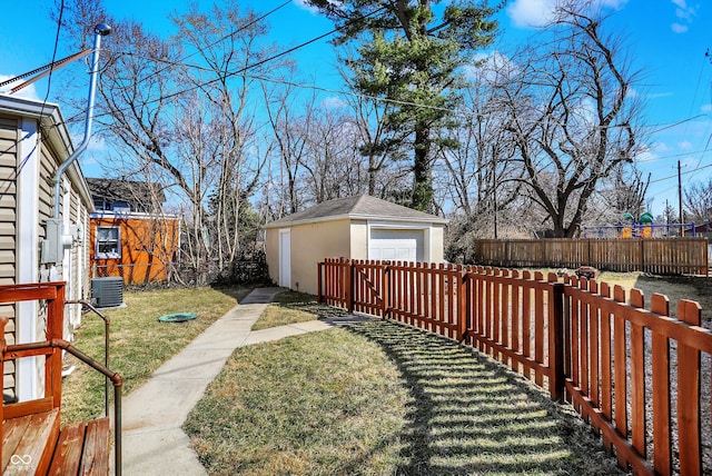 view of yard with an outdoor structure, central air condition unit, fence private yard, and a garage