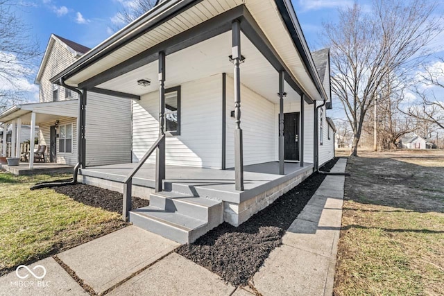 view of property exterior featuring a porch and a yard