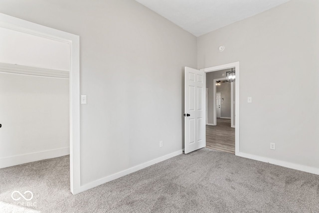 unfurnished bedroom featuring baseboards and carpet