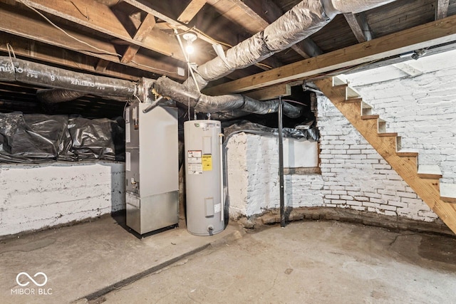 unfinished basement featuring heating unit and electric water heater