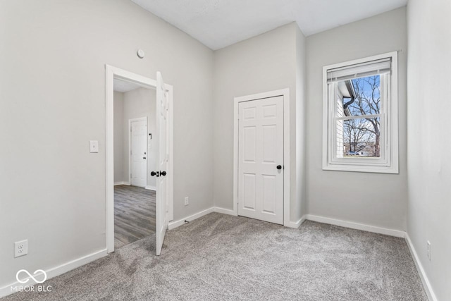 unfurnished bedroom featuring baseboards and carpet floors