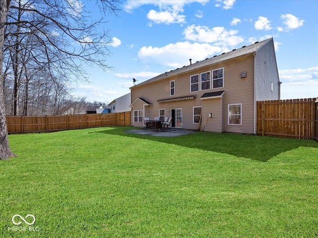 rear view of house with a patio area, a lawn, and a fenced backyard