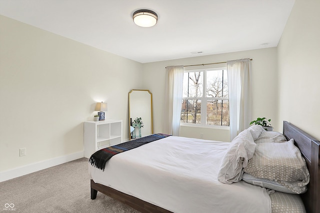 carpeted bedroom featuring baseboards and visible vents