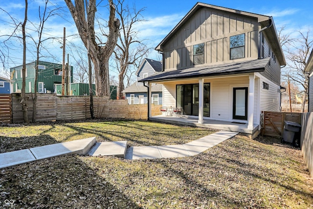 back of house featuring board and batten siding and fence private yard