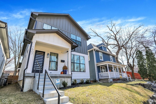 view of front of property featuring board and batten siding, a porch, and a front yard