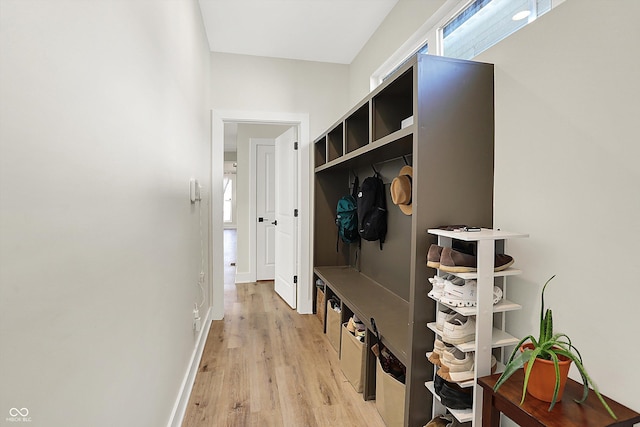 mudroom featuring light wood finished floors and baseboards