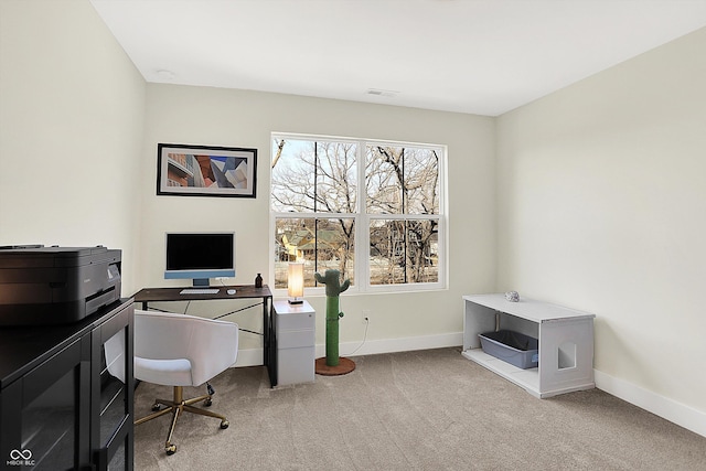 carpeted office featuring visible vents and baseboards