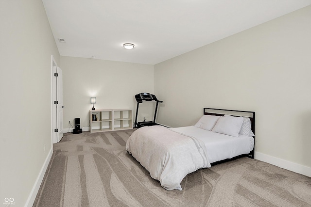 bedroom featuring baseboards and light carpet