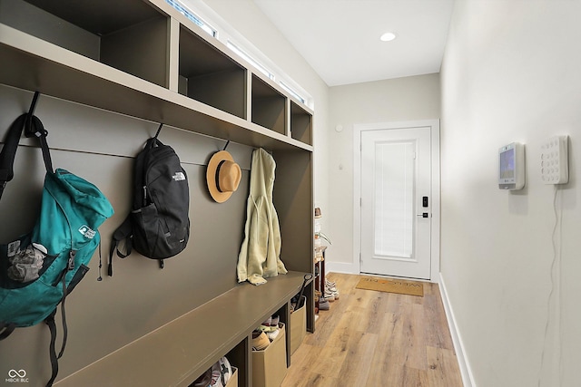 mudroom featuring recessed lighting, baseboards, and light wood-style floors