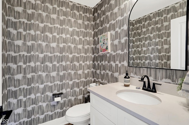 bathroom featuring toilet and vanity