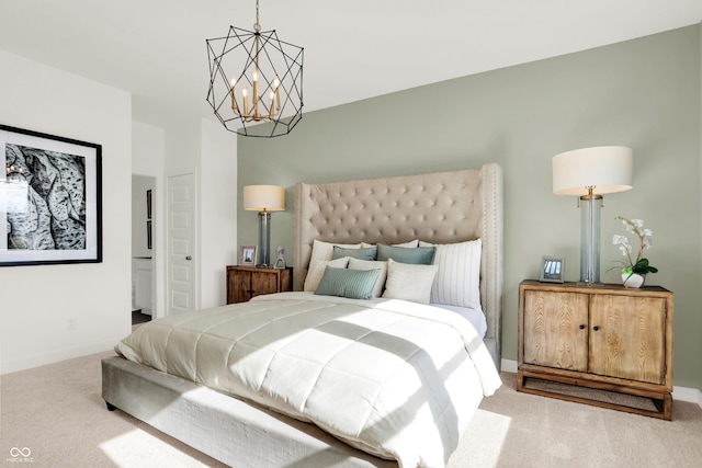 carpeted bedroom with an inviting chandelier and baseboards