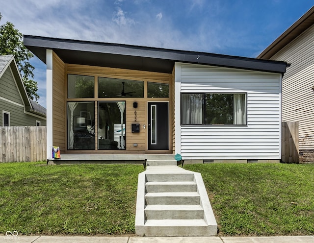 view of front of property featuring a front yard, a porch, fence, and crawl space