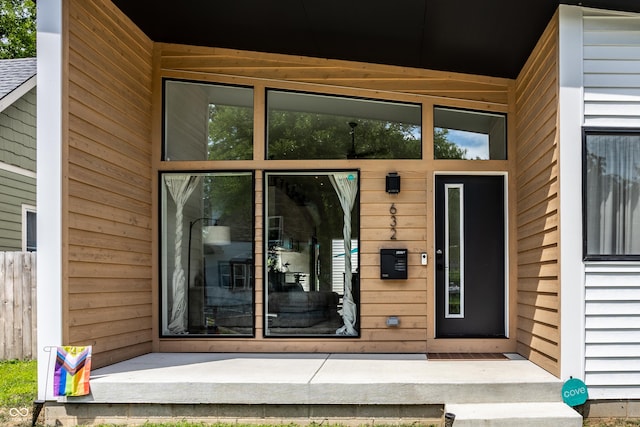 doorway to property featuring fence