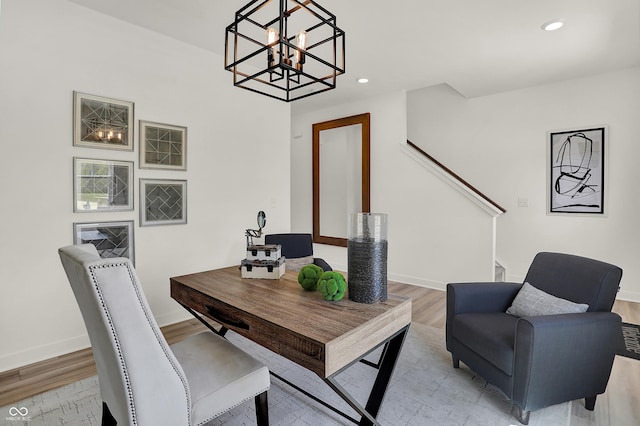 office space featuring a notable chandelier, recessed lighting, light wood-type flooring, and baseboards