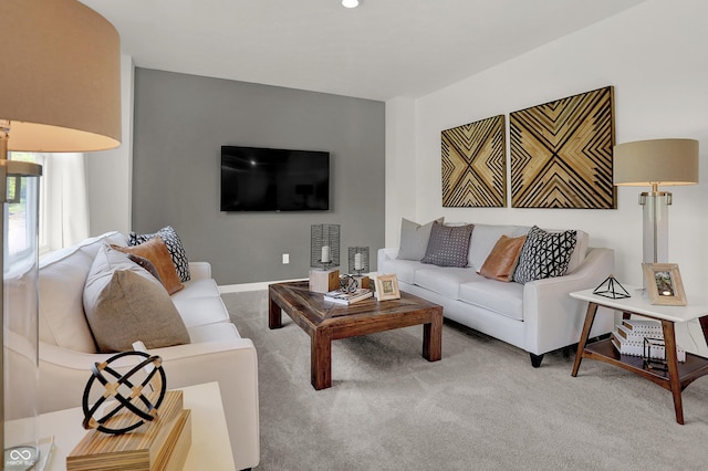 living room featuring carpet flooring and baseboards